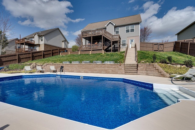 view of pool featuring stairs, a deck, a fenced backyard, and a fenced in pool