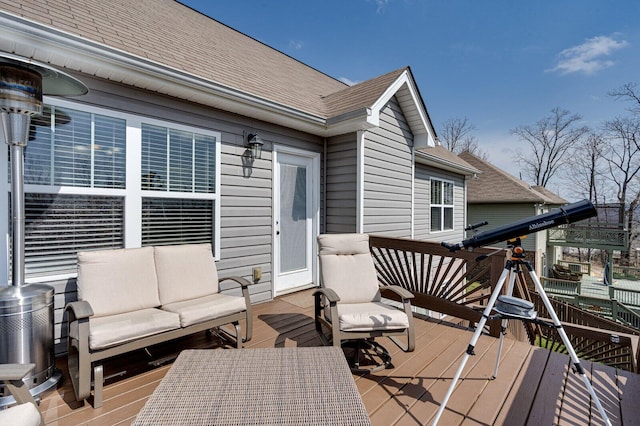 wooden terrace with an outdoor hangout area