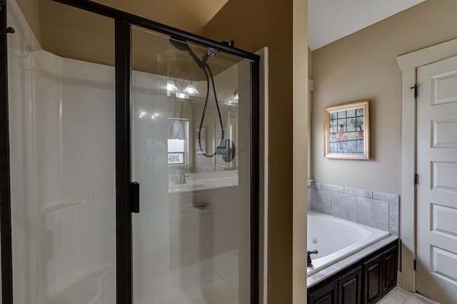 full bath featuring a tub with jets, a stall shower, and a sink