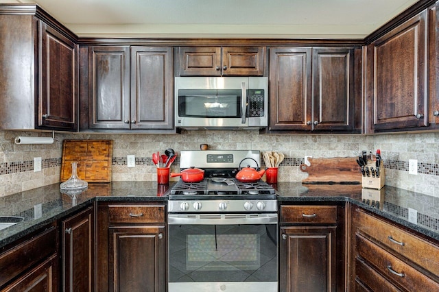 kitchen featuring dark stone countertops, stainless steel appliances, tasteful backsplash, and dark brown cabinets