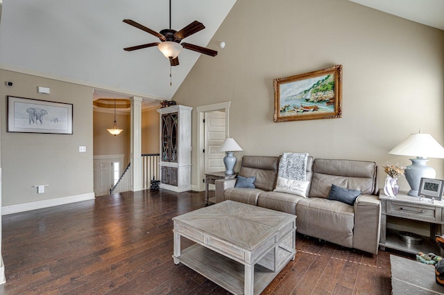 living area with hardwood / wood-style flooring, a ceiling fan, baseboards, and ornate columns