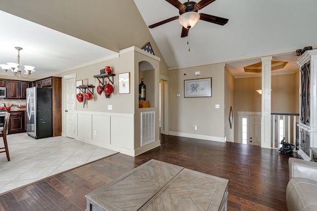 living area featuring visible vents, light wood-style floors, ornamental molding, and ceiling fan with notable chandelier