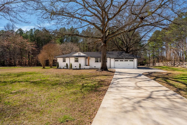 view of front of home with a garage, driveway, and a front lawn