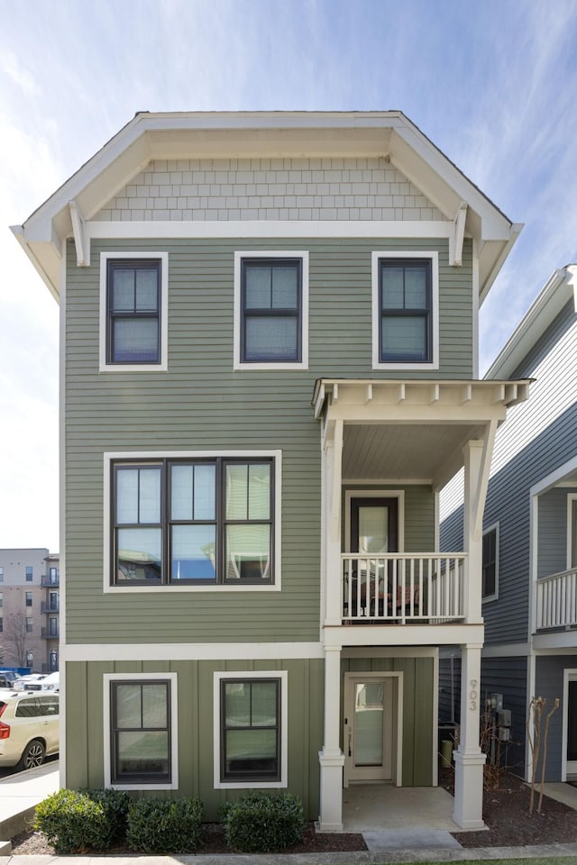 view of front of house featuring board and batten siding and a balcony