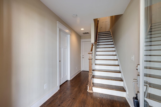 stairway with recessed lighting, visible vents, baseboards, and wood finished floors