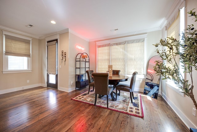 dining area with ornamental molding, visible vents, baseboards, and wood finished floors