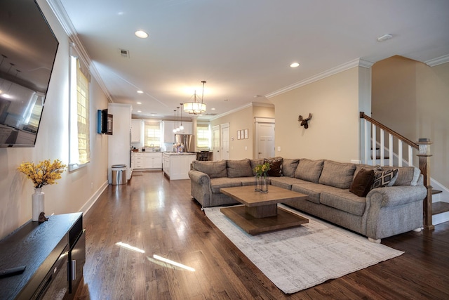 living area with dark wood-style floors, crown molding, recessed lighting, visible vents, and stairs