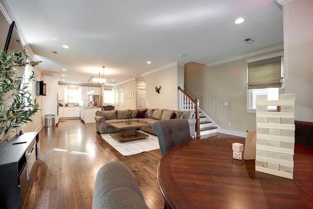 living area featuring visible vents, stairway, ornamental molding, dark wood-type flooring, and recessed lighting