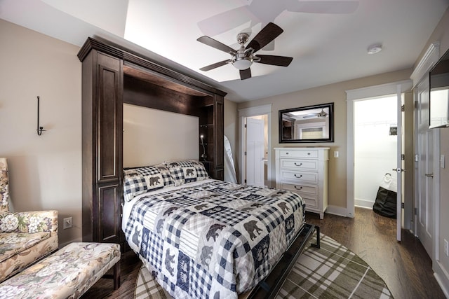 bedroom with ceiling fan, baseboards, and dark wood finished floors