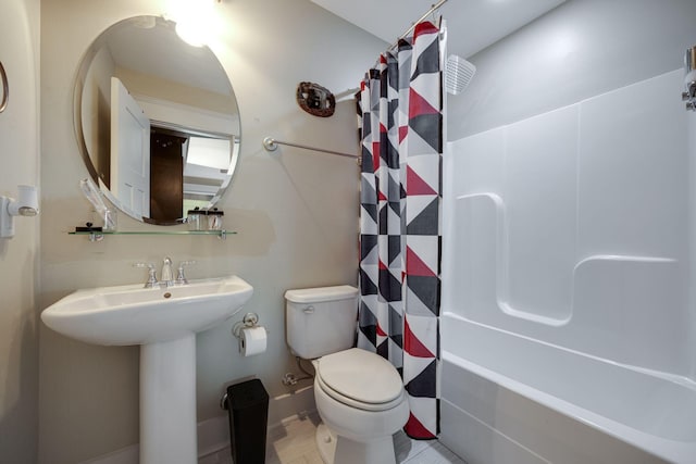 full bath with toilet, shower / bath combo, and a sink