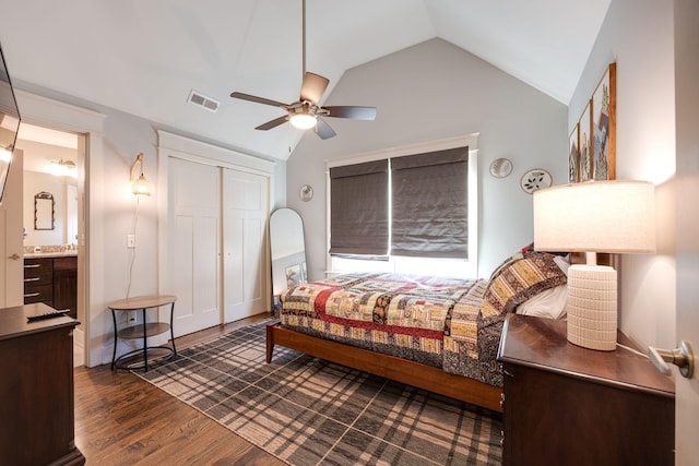 bedroom featuring visible vents, a ceiling fan, vaulted ceiling, a closet, and dark wood-style floors