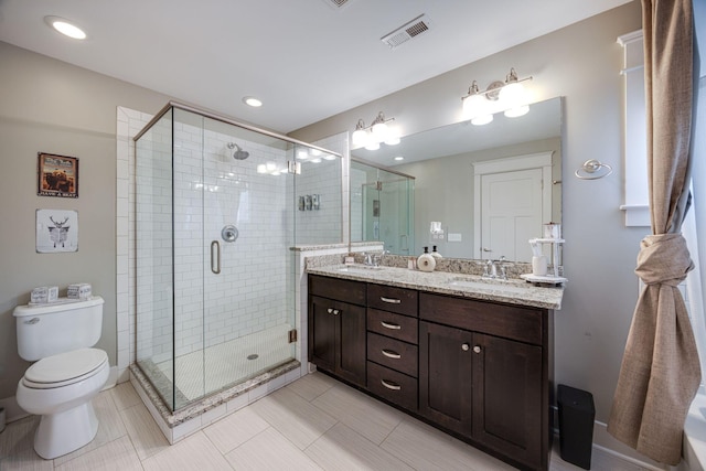 bathroom featuring double vanity, a stall shower, a sink, and visible vents