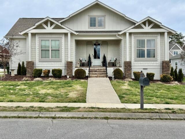 view of front of property with crawl space, covered porch, and a front yard