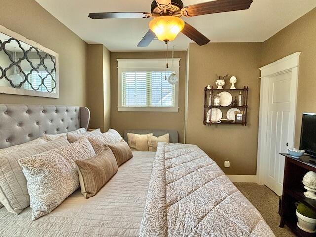 carpeted bedroom featuring ceiling fan