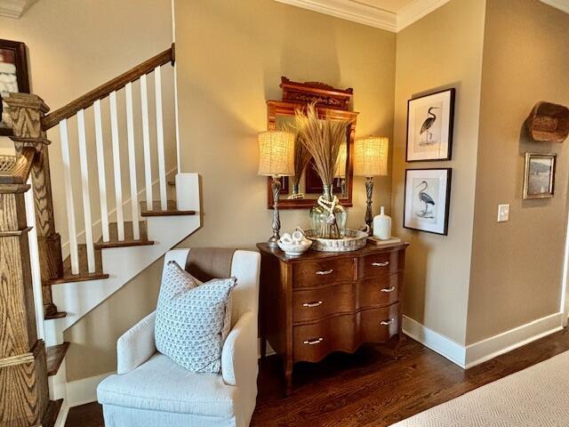 living area with crown molding, stairway, dark wood-style floors, and baseboards