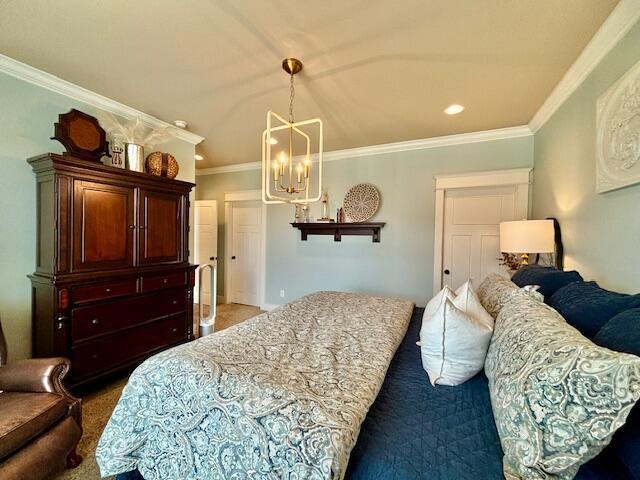 carpeted bedroom with an inviting chandelier, recessed lighting, and crown molding