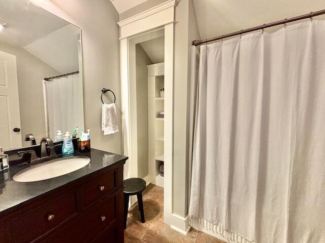 bathroom with vanity and vaulted ceiling