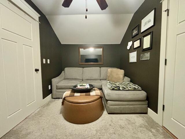 carpeted living area featuring lofted ceiling and ceiling fan