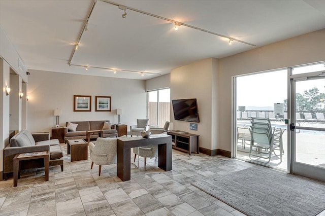 living room featuring baseboards and track lighting