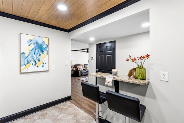 home office with a ceiling fan, recessed lighting, crown molding, baseboards, and wood ceiling