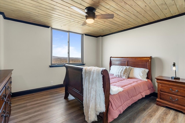 bedroom with dark wood finished floors, crown molding, and wood ceiling