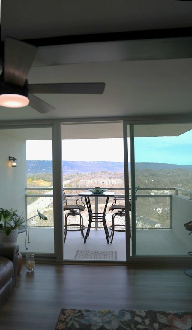 balcony featuring a ceiling fan and a mountain view