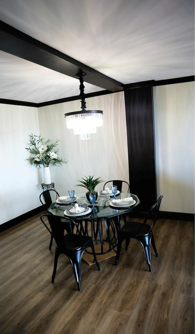 dining space with crown molding, beamed ceiling, wood finished floors, and baseboards