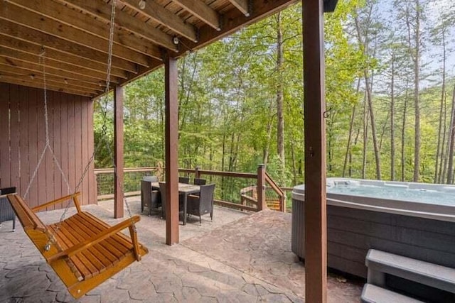 view of patio featuring outdoor dining space and a hot tub