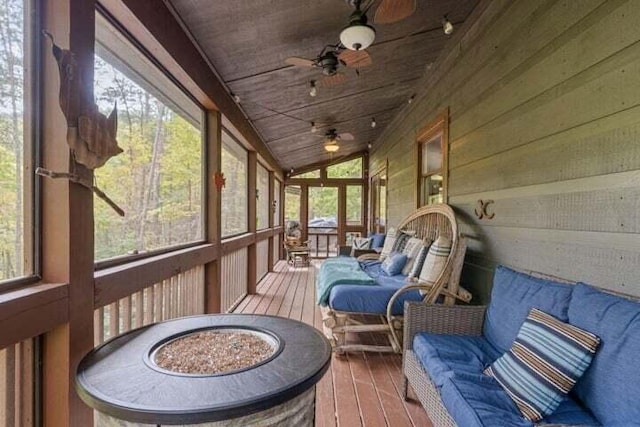 sunroom with lofted ceiling and a ceiling fan