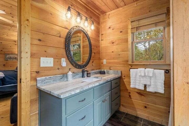 bathroom with vanity, wooden walls, and wood ceiling