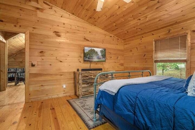 bedroom featuring wood ceiling, wood walls, hardwood / wood-style floors, and vaulted ceiling