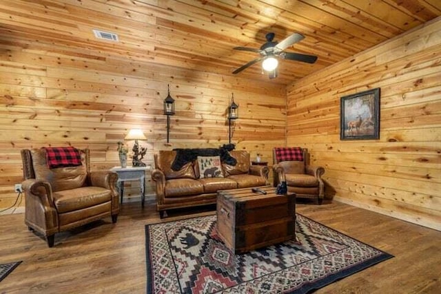 living room featuring ceiling fan, wood ceiling, wood finished floors, and wood walls