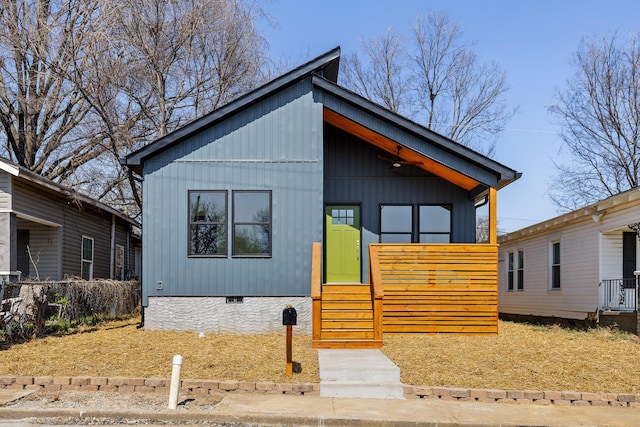 view of front facade featuring crawl space and board and batten siding