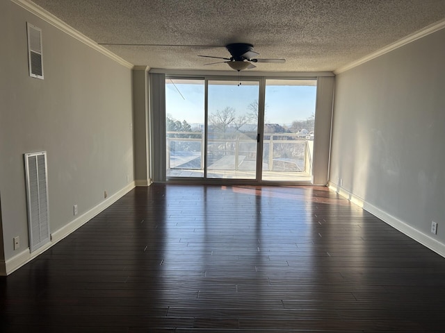 empty room featuring visible vents, dark wood-style flooring, and ornamental molding