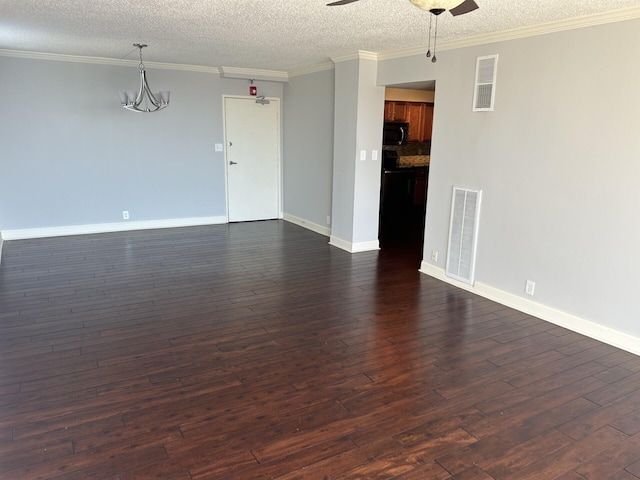 unfurnished living room featuring visible vents, ornamental molding, dark wood-style flooring, and ceiling fan with notable chandelier