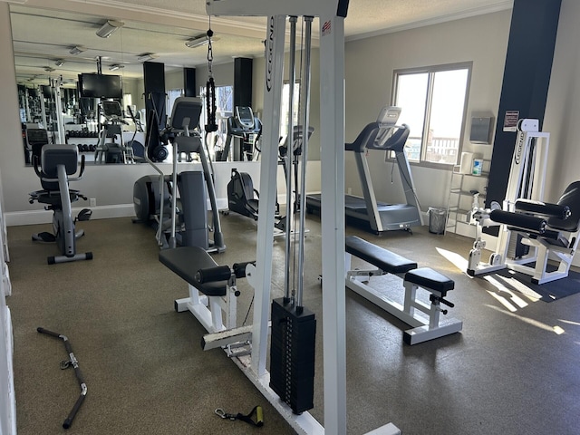 gym with baseboards and ornamental molding