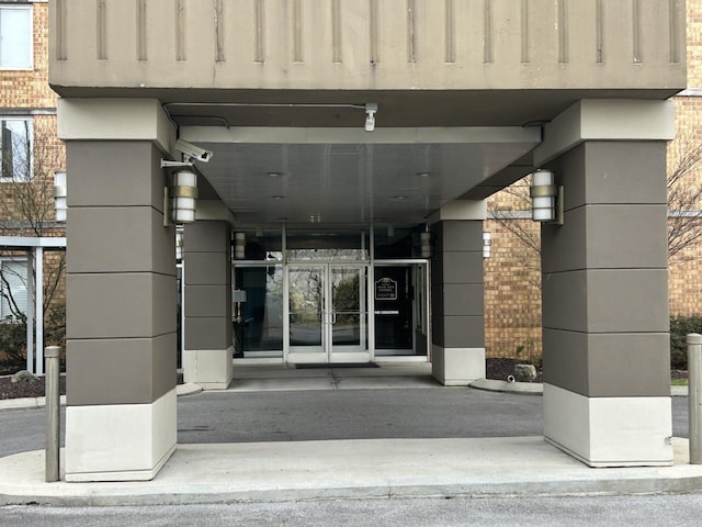 view of exterior entry with french doors and brick siding