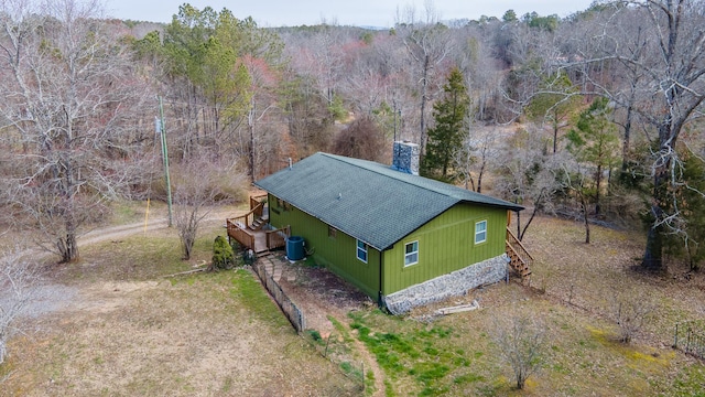 drone / aerial view with a wooded view