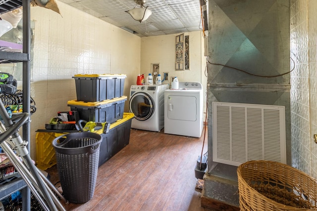 laundry room featuring laundry area, dark wood finished floors, and washing machine and clothes dryer