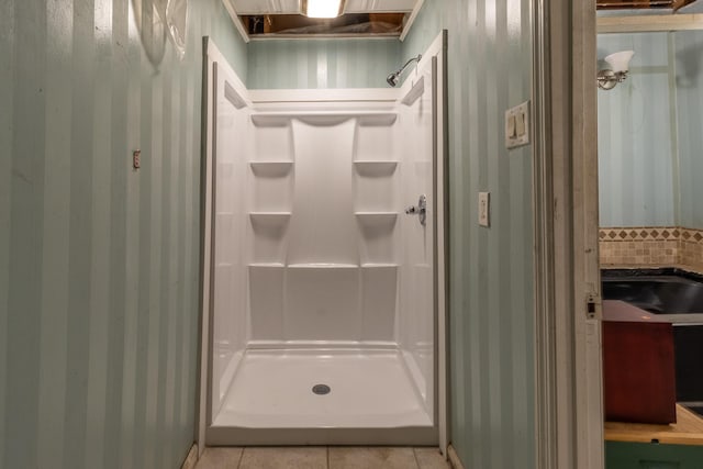 bathroom featuring a shower stall, decorative backsplash, and tile patterned flooring