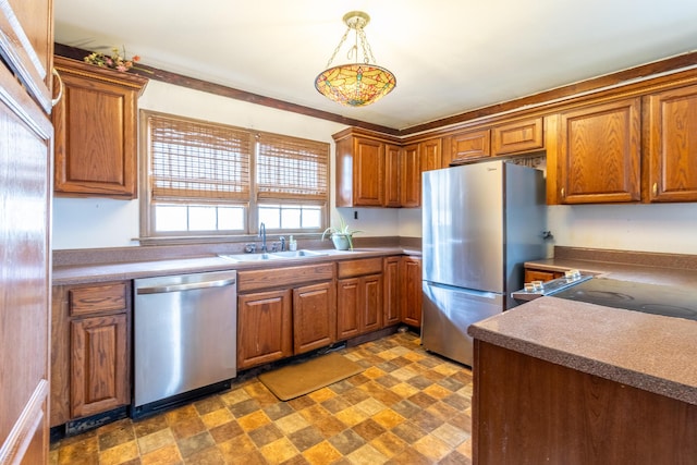 kitchen with stainless steel appliances, a sink, and brown cabinets