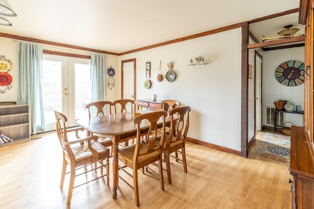 dining space featuring light wood-style floors, baseboards, and french doors