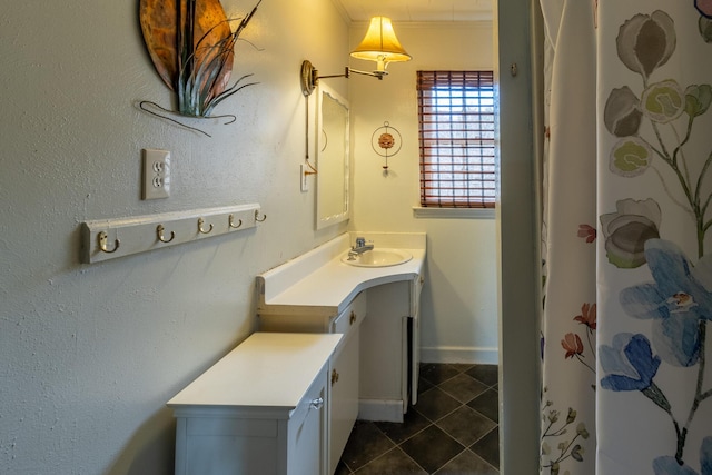 bathroom with ornamental molding, vanity, a shower with curtain, baseboards, and tile patterned floors