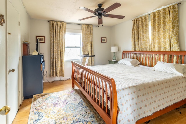 bedroom featuring a ceiling fan and light wood-type flooring