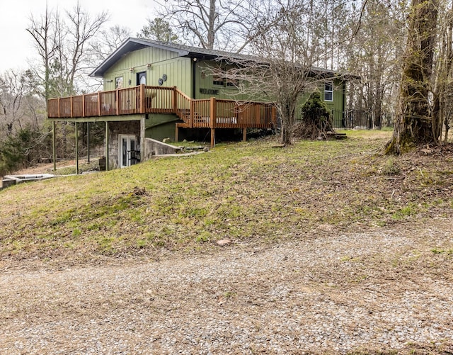 rear view of house featuring a wooden deck