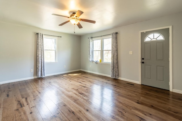 entryway featuring ceiling fan, wood finished floors, visible vents, and baseboards