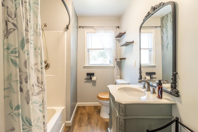 bathroom featuring vanity, toilet, wood finished floors, and baseboards