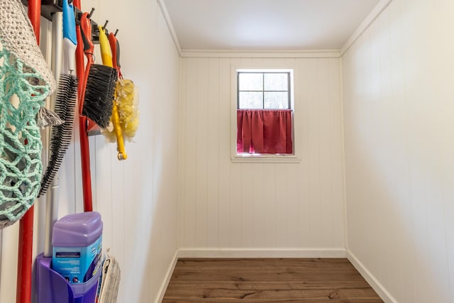 interior space with crown molding, wood finished floors, and baseboards