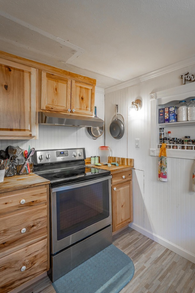 kitchen with under cabinet range hood, baseboards, light wood-style flooring, and stainless steel range with electric cooktop