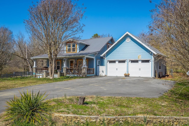 view of front facade with a front lawn, fence, aphalt driveway, a porch, and an attached garage